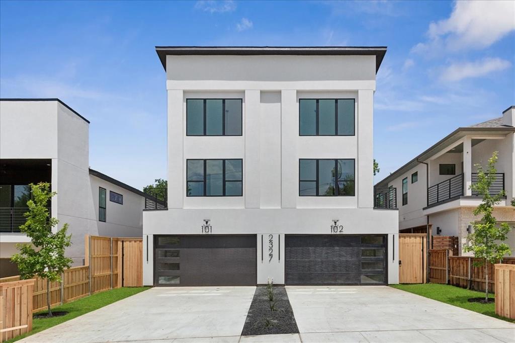 This spacious three story modern duplex is strategically positioned between uptown, downtown, and the medical district, with easy access to I-35 and NDT. It features an open floor plan with over 3,000 sq ft., 4 BR and 3.5 baths, rooftop and outdoor balconies, plus a tall privacy fenced in backyard, perfect for relaxing and entertaining. This luxury duplex is enhanced by white oak hardwood floors, large windows for lots of natural light, electric fireplace, quartz countertops, custom cabinets, spa-like bathrooms and security gate. The first floor contains the open living space, kitchen, dining room, and double car garage, while the second floor features the master bedroom with en-suite plus two additional bedrooms and bath. The third floor unveils yet another large bedroom with an en-suite bathroom and rooftop access. Don't miss this opportunity to own a luxury home with two master suites, in this up and coming neighborhood.