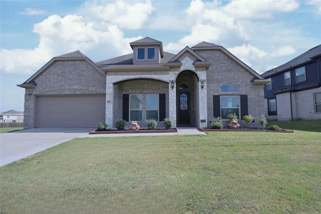 GORGEOUS barely lived in 4 BEDROOM-2.5 BATH single story Home located in CEDAR HILL's BEAR CREEK Addition at 1802 RANCH VIEW DRIVE!! Loaded with upgrades and close proximity to Hillside Village Shopping Center, Joe Pool Lake, I-35 E, HWY 67 and approx. 18 miles to Downtown Dallas! Beautiful wood floors in all main living areas, extensive crown molding, multiple arched entries, neutral colors throughout and a stunning wrought iron accented front door. Spacious open concept floorplan with wide open spaces, offering everything you need for everyday living or entertaining. The oversized Kitchen is a Chef's dream, with an abundance of cabinet and counter space, 42 inch uppers, granite countertops, huge Island, subway tiled backsplash, deep under mount sink, stainless steel appliances, double ovens (one convection), pot & pan drawers, cookie sheet drawer and deep 5 shelf walk-in pantry. Kitchen opens to Butler's Pantry, both Dining areas, Living with corner cast stone electric fireplace, a back wall of windows and plenty of natural light. Versatile front flex space, guest half bath with pedestal sink and nice split Bedroom arrangement for privacy. Large Owner's Retreat with sitting area, en-suite bath with two separate vanities, oversized shower, garden tub and large double racked walk-in closet. 4th Bedroom-great optional Office with French entry door, perfect for those who work out of the house. Oversized Laundry with shelf, drip dry rod and room for freezer or folding table. Nicely landscaped yard, wide front covered sitting porch, covered back patio, big 6 ft. privacy fenced backyard, epoxy coated garage floor and more, plus rear solar panels to help save $$ on your Energy Bill, that will be paid off at Closing by the Seller. Community Playground, Walking Trails and a Pickle Ball Court too! Come and see all this fabulous Home has to offer! Schedule your showing today!