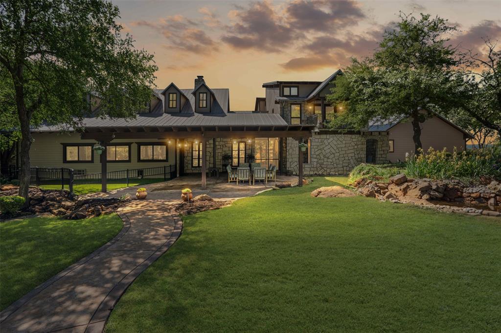 Introducing a truly exceptional, Beverly Hills-inspired estate nestled on 1.5 meticulously landscaped, park-like acres in the highly sought-after Aledo ISD. This distinctive property is a masterclass in design and craftsmanship, blending timeless architectural elements with modern sophistication.

From the moment you arrive, the elegant façade and bespoke details signal a residence of rare caliber. Inside, you're greeted by rich, hand-scraped hardwood floors, exquisite custom millwork, and three impressive fireplaces that create a warm yet refined ambiance.

The grand living room is a showstopper—anchored by soaring vaulted ceilings, dramatic wood beams and columns, a striking stone fireplace, a dazzling chandelier, and a luxe wet bar ideal for entertaining at scale. The chef’s kitchen is nothing short of exceptional, featuring a professional-grade Dacor six-burner range with double ovens, dual dishwashers, a built-in wine station, and an espresso bar. The adjoining butler’s pantry is equally well-appointed, offering a full serving station and four warming drawers and adjacent is an elegant large wine cellar —ideal for hosting large gatherings or intimate dinners.

A formal dining room and dedicated wine room elevate the entertaining experience even further. The primary suite is a private sanctuary, complete with a spa-like bath and a boutique-style dressing room worthy of a fashion atelier. Additional highlights include a sophisticated private office, a full in-law suite with its own living space and kitchen, and a third-floor media room and bonus room for added flexibility.

Step outdoors and you'll find a true entertainer’s paradise—an expansive resort-style pool and patio with panoramic, unobstructed views that stretch for miles over the rolling countryside of Parker County.

More than a home—it's a lifestyle statement for the discerning buyer seeking elegance, privacy, and luxury. Offered fully furnished. Pilots, KWEA is less than 1.5 miles.