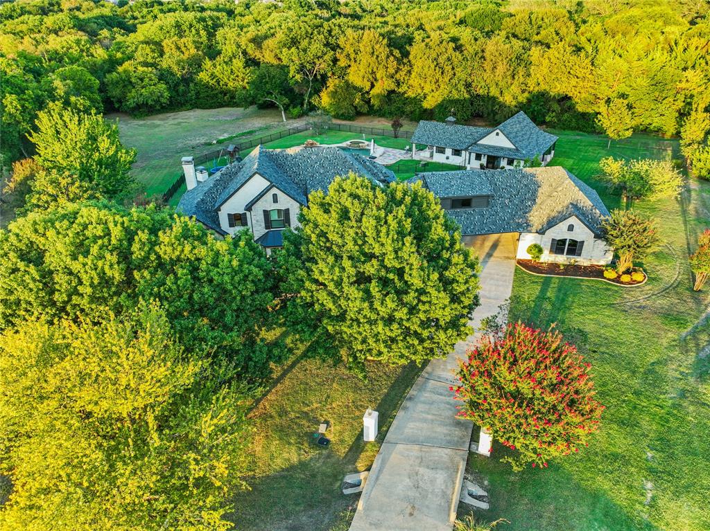 FULLY UPDATED home on 3 acres in coveted Lovejoy ISD. Through the iron front door, you will find the formal living room on the left and a formal dining room with a gorgeous accent wall on the right. The large family room boasts a stone wood-burning fireplace and an amazing view of the private backyard. The state-of-the-art kitchen features an appliance garage, a built-in trash pullout and a 6-burner Forno range. On the ground floor, let the bright master bath wow you with its oversized shower with two rain shower heads and light-up mirrors. The game room with its wet bar and media room upstairs form the entertainment part of the home. The fifth bedroom is currently used as a gym. Enjoy those TX sunsets on your covered patio while warming up to a fire in the winter and grilling to your heart's content. The casita will welcome your guests in style with its oversized kitchen, full bathroom, bedroom and living room.