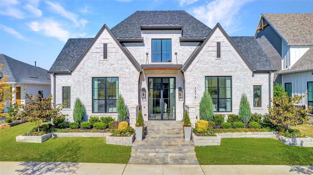 ELEVATED LIVING, EXPERTLY SCALED! This stunning SINGLE story home is a rare opportunity! A sculpted landscape of vibrant greenery leads to a dramatic glass front entrance with modern tudor presence. Upon entry you met with soaring 22 foot ceilings, designer lighting, walls of windows, and timeless style. Impressive great room flows effortlessly into chef's kitchen featuring Wolf Subzero appliances, quartzite waterfall island, and custom cabinetry. The impeccably designed prep kitchen is a standout feature enhancing both form and functionality. It includes a second dishwasher, sink, ice maker, Subzero refrigerator, outdoor access, and more crafted cabinetry and storage. Work from home in private glass enclosed office with custom built-ins and refined details, ideal for productivity and sophistication. Enjoy a full cinematic experience in media suite. The highly desired Olivier plan thoughtfully delivers four spacious bedrooms all with private bath and separation on one floor. Retreat to serene primary suite featuring spa bath and large custom wardrobe. The primary bathroom also opens to your outdoor oasis, blending luxury and relaxation. Enjoy an espresso or savor a Texas sunset on the perfectly appointed patio while taking in the beautifully curated spaces. Experience luxurious outdoor living and dining with full kitchen, powder bath, fireplace, and automated screens for elevated privacy and ultimate comfort, enhanced by vibrantly tailored landscaping that delivers a pristine exteriors. Every space has been intentionally crafted with design and exceptional livability in mind. Experience the finest living in the Frisco Fields. This community delivers a curated roster of amenities, from modern fitness centers and instructor led classes to dedicated pickleball and tennis courts with resort style pools. Its unbeatable location places you steps from championship caliber PGA golf and an array of world class dining experiences!