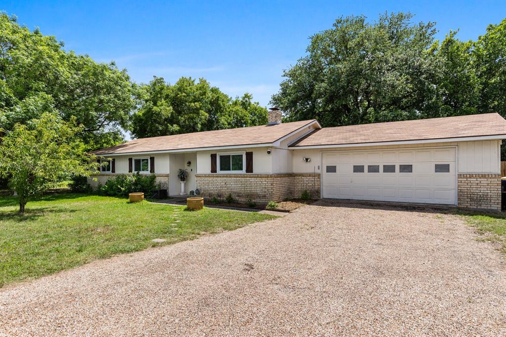 Rare opportunity to own a total of 2 acres in Lorena, featuring a 3-bedroom, 2-bath home, an attached 2-car garage, and an adjoining 1-acre lot being sold together as one package. The additional lot already has water and sewer hookups in place, providing exceptional flexibility for future expansion, additional improvements, investment potential, or simply added privacy and space.

Located adjacent to Lorena ISD campuses and shaded by mature trees, this property combines the convenience of town with the freedom of country living. Inside, you'll find a welcoming floor plan featuring a dedicated foyer, spacious dining area, comfortable living room centered around a beautiful two-sided brick fireplace, and a functional kitchen with easy access to the outdoor living space. The oversized primary suite is complete with an ensuite bath and walk-in closet, while two secondary bedrooms and a full hall bath provide comfortable accommodations for family and guests.

Step outside to enjoy the covered patio overlooking the property and the endless possibilities that come with 2 acres. Whether you're dreaming of a large garden, keeping horses or chickens, creating a hobby farm, or simply enjoying extra room to roam, this property offers the flexibility to make it your own. Additional improvements include a storage shed and a one-stall barn, making it well-suited for animals, projects, and equipment storage.

Conveniently located with easy access to I-35 and just minutes from Waco, this unique property offers a rare combination of acreage, utilities, animal-friendly space, and a prime Lorena location.