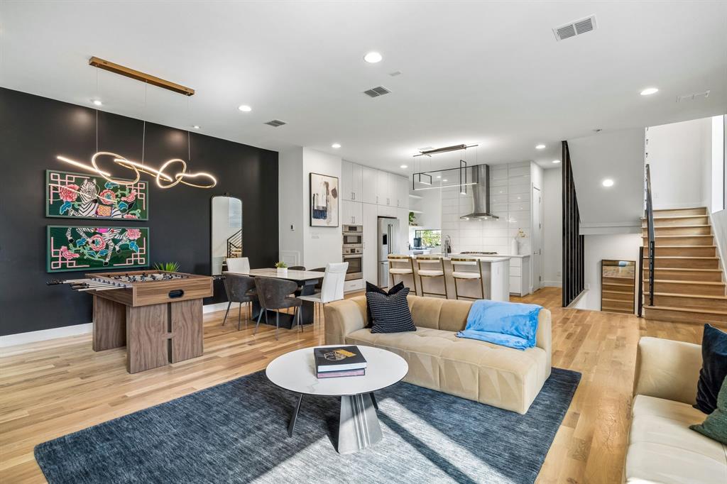 Stunning modern duplex in East Village with no HOA, designed by AIA award-winning architect Josh Nimmo and built by Cobalt Homes.
The striking interior showcases luxurious finishes, including white oak hardwood floors, smooth-finish walls, solid-core doors, designer lighting, and high-end cabinetry throughout. The kitchen is thoughtfully designed with Bosch appliances, quartz countertops, floor-to-ceiling cabinetry, and a coffee bar with a beverage refrigerator, opening to the main living area highlighted by distinctive architectural details.
A first-floor bedroom with an ensuite bath provides flexibility for guests or a private home office. The primary suite features generous closets and a spa-inspired five-fixture bath.
The home is equipped with a zoned HVAC system, spray-foam insulation, air purifier, and tankless water heater, offering enhanced energy performance and year-round comfort. The attached 2-car garage includes an electric vehicle charging outlet for added modern convenience.
The rooftop terrace, finished with newly installed premium deck tile, captures impressive views of the Downtown Dallas skyline, creating an exceptional setting for entertaining or quiet evenings. Ideally located just minutes from Downtown, Uptown, West Village, Knox-Henderson, and the upcoming The Central mixed-use development, with premier dining and entertainment close at hand.
Offered furnished, this residence presents a rare opportunity for immediate, turnkey living or a sophisticated short-term rental investment.