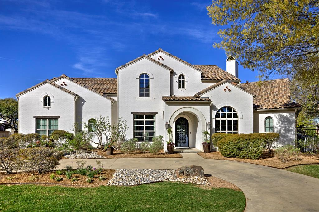 This custom Mediterranean Estate built by Glendarroch Homes in 2017, is located within the exclusive gated and guarded golf course community of Mira Vista and is perfectly positioned along the 17th fairway, offering breathtaking views from nearly every room. Expansive windows fill the home with natural light while showcasing the resort-style pool and outdoor living spaces, creating an ideal setting for relaxation and entertaining. The gourmet kitchen is a chef’s dream, featuring quartz countertops, professional-grade appliances, a large island, and an oversized pantry. The butlers pantry and wine room are an entertainers dream! The primary suite serves as a private retreat with a spa-inspired ensuite, complete with a freestanding soaking tub, separate shower, dual vanities, and a custom walk-in closet, while a guest bedroom with its own ensuite is also conveniently located on the main level. Upstairs, you’ll find three additional guest bedrooms, two full baths, a media room, exercise room, and a game room with a full wet bar. Large sliding glass doors seamlessly connect indoor and outdoor spaces, enhancing the home’s entertaining appeal. The oversized three-car garage features epoxy flooring, and the backyard offers a spacious pool and spa with multiple water features, a grilling area, wood-burning fireplace, and multiple balconies and porches-all designed to capture stunning golf course views from every angle of the property.