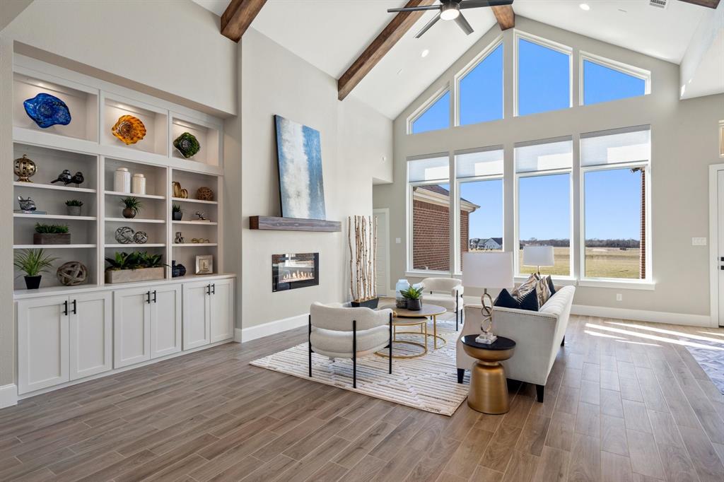 Step into a life of luxury & innovation with this extraordinary custom-built, energy-efficient smart home, set on a 1-acre lot. Combining high-end finishes with sustainable living, this property offers a unique investment opportunity. Don’t miss this chance to secure an exceptional home that balances refined living with everyday cost savings. With a thoughtfully designed layout, this home features 4 spacious bedrooms, 4 full baths, and 2 half baths. Enjoy multiple versatile spaces, including a dedicated study, a game room, and a state-of-the-art media room, catering to work, relaxation, and entertainment needs alike. Main living area is a showstopper, featuring a grand cathedral ceiling with wood beams & abundant natural light streaming through expansive windows fitted with motorized shades, effortlessly enhancing both the ambiance & convenience of the space. The heart of the home is its chef-inspired kitchen, where an oversized island doubles as a casual dining space & prep area. Custom cabinetry reaches up to the ceiling, with glass-front upper cabinets adding an elegant touch. A built-in wine rack sits above the wine fridge, while double ovens with Wi-Fi capabilities offer both functionality and sophistication. This kitchen is designed not just for cooking, but for creating memorable experiences. The primary suite serves as a private retreat, with a spa-like bath featuring double vanities and a freestanding bathtub. Smart home technology extends throughout, integrating seamlessly into daily life to enhance comfort and improve energy efficiency, keeping utility costs low and making everyday routines easier. Home offers an unparalleled lifestyle focused on wellness, advanced technology & sustainable design. It’s more than a residence; it’s a statement of quality & foresight, where every detail has been crafted to deliver a unique and elevated experience. Don’t miss the opportunity to own this exceptional property. **Ask About Lease Purchase Option Available**