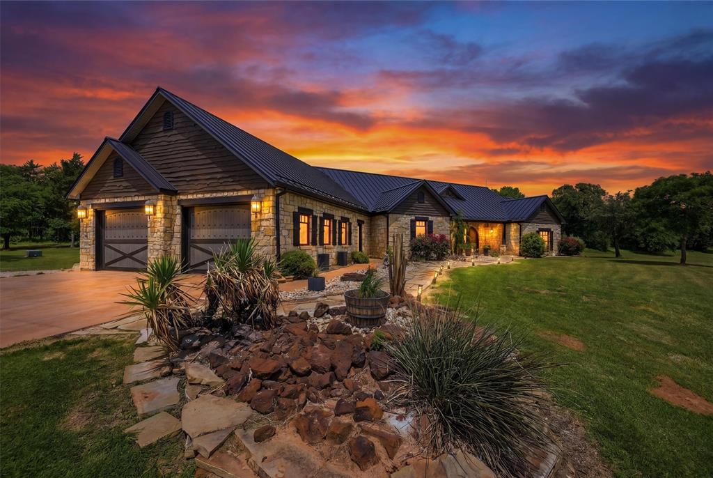54 acres of heaven! Custom ranch estate featuring a luxurious 3,118 sq ft main home, 915 sq ft guest house, equestrian facilities, and extensive upgrades throughout. The 3BR-2.5BA main residence offers vaulted wood-beam ceilings, porcelain tile floors, Lutron lighting, surround sound, and three dry-stacked gas fireplaces. The spacious living area showcases a dramatic stone fireplace, custom French doors, and access to the covered outdoor entertaining patio. An elegant dining room features a custom crystal chandelier. The private primary suite includes surround sound, a fireplace, patio access, and a spa-inspired bath with a Kohler jetted tub, oversized walk-in shower, dual copper sinks, granite countertops and custom walk-in closet. Guest bedrooms share a Jack-and-Jill bath with heated floors and a steam shower. The chef’s kitchen features granite countertops, custom cabinetry, copper fixtures, a large island with 5-burner gas cooktop, Jenn-Air appliances, double ovens with warming drawer, walk-in pantry, and breakfast nook. A dedicated wine room stores approximately 500 bottles and also serves as a reinforced safe room-tornado shelter. Outdoor living includes a covered patio with fireplace, outdoor kitchen, granite counters, and multiple seating areas. Additional amenities include mahogany doors, irrigation, Kohler generator, aerobic septic system, 3 HVAC units, mature landscaping, and an attached 2-car garage. The guest house offers 2 bedrooms, a Jack-and-Jill bath, full kitchen, limestone fireplace, washer-dryer, and covered porch. Equestrian improvements include an insulated 84x38 show barn with 7 Noble stalls, turnouts, tack room, wash rack, studio apartment, automatic waters, round pen, fenced traps, stock ponds, and feed barn. A detached 32x61 insulated shop provides 3 bays plus drive-through access. With over 5,100 ft of road frontage and two entrances, country living at its finest with easy access to town. For the full 84-acre offering, see MLS #21248624.