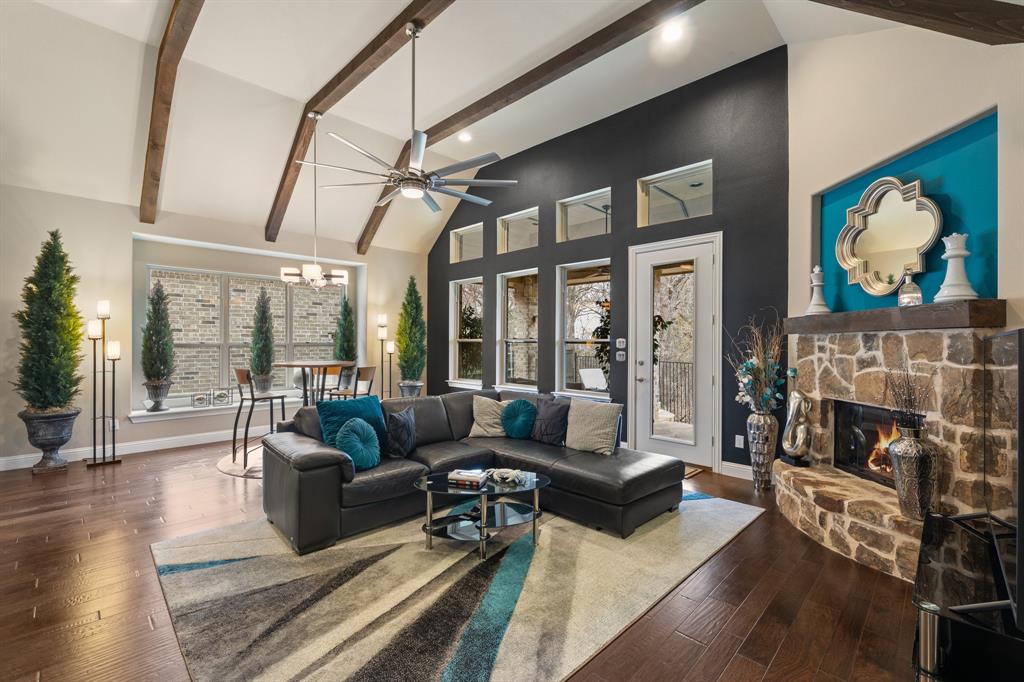 Tucked away on a premium lot in the highly sought-after Stone Bridge Oaks community, this exceptional custom Grenadier home blends luxury, comfort, and the ease of low-maintenance living. Thoughtfully designed with quality craftsmanship throughout, every space feels refined, inviting, and effortlessly livable.

Rich hardwood floors, striking beamed ceilings, extensive custom built-ins, and designer finishes make an unforgettable first impression. The open-concept floor plan is ideal for both everyday living and entertaining, with spacious gathering areas flowing seamlessly together. At the heart of the home, the beautifully appointed kitchen features abundant cabinetry, generous prep space, and a large island overlooking the living and dining areas.

The spacious primary suite offers a peaceful retreat, while the spa-inspired bath provides a luxurious escape with elegant finishes and abundant storage. A secondary bedroom on the first floor offers flexibility for guests, multigenerational living, or a private home office.

Upstairs, enjoy a professionally designed custom home theater with luxurious seating for the ultimate movie or game-day experience, along with spacious secondary bedrooms and a convenient study nook. Every space has been thoughtfully designed to adapt beautifully to both entertaining and everyday life.

One of the home’s greatest advantages is its true lock-and-leave lifestyle. The HOA maintains the front & back landscape & the irrigation systemexterior of the home—excluding the roof, gutters, and downspouts—allowing you to spend more time traveling and enjoying life. Residents also enjoy access to a community gathering space, swimming pool, and fitness center.

Just minutes from premier shopping, dining, golf, parks, DFW Airport, and everything that makes Stone Bridge Oaks so desirable, 
this exceptional custom residence offers the rare opportunity to simply lock the door, travel with confidence, and come home to effortless luxury.