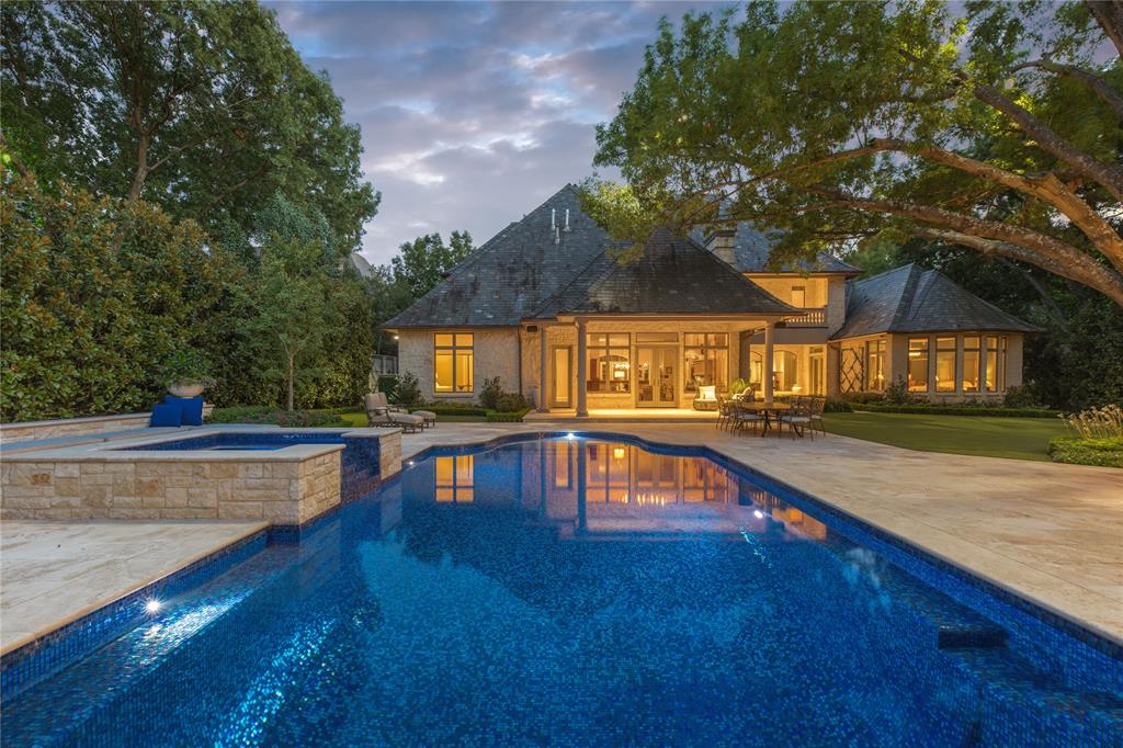 Serene and peaceful, this completely updated gated estate offers a premier Preston Hollow estate location and meticulous attention to detail. Completely transformed by the current owners, with updated kitchen and baths and reimagined spaces. The grounds are fully perimeter secured and were designed and implemented by Harold Leidner, with tiled pool, turfed yard, gorgeous Magnolias offering a complete screen for privacy, and fire pit and seating area. Also outdoors is a cabana with kitchen and full bath. Indoor features include downstairs primary suite, guest suite with walk-in shower, two offices, including one with fireplace, two powder baths, replaced kitchen and bar appliances and updated finishes. Wet bar with wine storage. Upstairs includes three bedroom suites, game room with private balcony, powder bath, exercise room with reinforced flooring, and full media room with updated projection. Elevator access to both floors. 4 car garage and motor court includes electric charger.