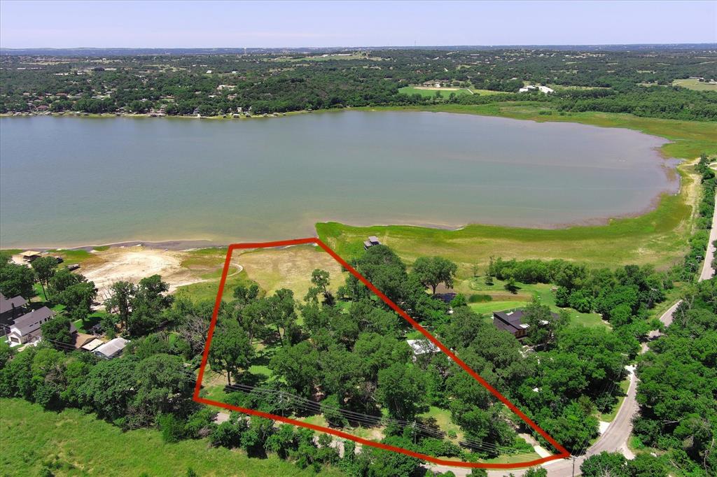 Lake Weatherfird Leasehold Property - whether you want to chill while floating, are a boating family, fishing, this place offers you your own piece of privacy and quiet to enjoy sunsets, sunrises, birdsong, and get away from it all.  Of course, with shopping and restaurants and hospitals within a few miles, you can rest assured that your needs an be met quicky.  This house was built in 1960 and has hosted so many family and friends gatherings, it is beyond counting!  Cabin is small but serves the purpose of hosting for fun weekends. Back patio is perfect for sitting!  3 bedrooms and one and a half baths.  House is sold AS IS and most furnishings and household items can convey with the home.  4 lots constitute this beautiful treed property and it is all waiting for you to begin your own family memories.