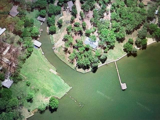 Prime 10-Acre Waterfront Development Opportunity on Cedar Creek Lake. Attention investors and developers: a premier waterfront commercial opportunity awaits. This exceptional 10-acre hilltop property boasts commanding, elevated views of Cedar Creek Lake and comes fully equipped with two houses, a cabin, and a private boat ramp. Covered in beautiful oak trees, the rolling topography is uniquely suited for high-yield income generation. The flexible acreage is an ideal canvas for a luxury RV park, a trendy tiny-home village, or a premium vacation rental resort. Capitalize on the booming lakefront market with a versatile property that offers an easy transition into a lucrative investment.