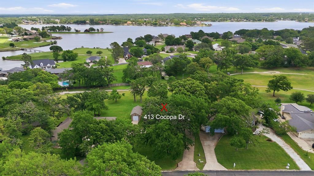 Lake Kiowa is ideal for full-time living or a weekend retreat. The community hosts beloved gatherings for 4th of July fireworks, Labor Day and Christmas to name just a few. This gorgeous property offers the perfect blend of lake community living and peaceful golf-course views. The home sits on a beautiful, heavily treed lot and features a highly desired circular drive plus an oversized drive-through garage with 18' doors and a detached third-car garage or workshop. One of the best features is the private, serene 51' x 11' screened-in porch overlooking panoramic views of Hole #14 and the lake in the distance. Inside offers an open floor plan with rich wood-paneled walls, a newer wood stairway, a dramatic wood-vaulted ceiling, a wall of windows, and a striking wood catwalk. This home lives more like a 1.5-story than a traditional 2-story. The catwalk connects two additional rooms with a powder bath, making this level ideal for guest bunks, an office, or flexible living space rather than a true full bedroom wing. For that reason, the property is best considered a 3-bedroom home with 2 flex rooms and is priced accordingly. Lake Kiowa is a private, 24-hour guard-gated community built around a 600-acre spring-fed lake with boating, fishing, kayaking, and swimming. Residents enjoy two manicured beaches with playgrounds, covered pavilions, picnic areas, and community restrooms, plus an 18-hole championship golf course with practice facilities, a pro shop, and a fun Par 3 course. Additional amenities include lighted basketball, tennis, and pickleball courts, walking paths, Little Fox Pond for kids 16 and under with year-round fishing events, multiple boat launches, and The Lodge with dining, bar, patio seating, and spaces for community activities.