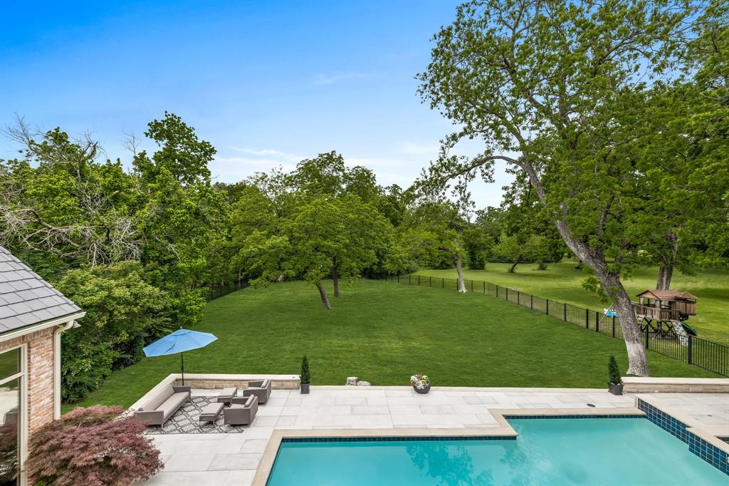 Stunning, fully updated estate on private .79 acre lot backing to White Rock Creek in prestigious guard gated Harbord Oaks Estates with Plano ISD. Soaring ceilings and walls of windows flood the interior’s oversized rooms with natural light and provide breathtaking panoramic views throughout. Massive gourmet kitchen features Wolf and SubZero appliances, grand island and custom chef prep kitchen, pantry with beverage center. Private primary suite down, includes large sitting area with fireplace, wall of windows and gorgeous spa bath retreat with heated floors, coffee bar, 2 water closets, large steam shower and his and hers custom closets. Guest suite and study down with 3 additional on-suite bedrooms up along with oversized game room with wet bar and full media room with wet bar and bath. Enjoy the gorgeous pool and spa overlooking sprawling treelined oasis. Additional amenities include elevator, whole house generator,2 feet attic insulation and new driveway and pool decking.