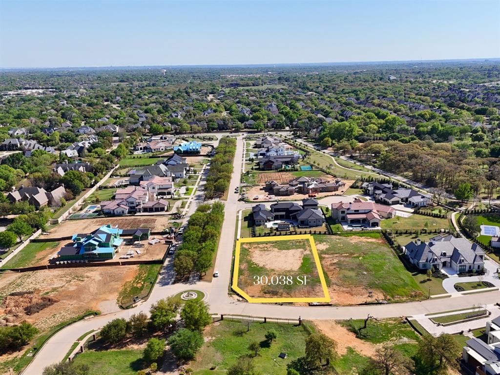 Providential Custom Homes, a Master Builder-certified custom home builder presents this .68 acre corner property tucked away at the end of a quiet cul-de-sac inside Colleyville’s prestigious Oak Alley Estates. This exceptional homesite offers a rare opportunity to build a custom luxury residence in one of the city’s newest gated communities. As you arrive through the private gates, you’re greeted by mature trees and a peaceful, park-like setting that immediately sets the tone for refined estate living. This premium lot enjoys added privacy thanks to its corner positioning and generous size, providing ample space for a thoughtfully designed custom home, outdoor living areas, and lush landscaping. Oak Alley Estates is an intimate enclave of just 34 estate homesites spanning 43 acres, designed with underground utilities, private concrete roads, scenic walking trails, and striking water features throughout the community. Perfectly located in the heart of Colleyville, with convenient access to nearby parks, boutique shopping, dining, and everyday amenities, while remaining minutes from DFW International Airport, Highway 114, and Highway 26. Zoned to highly regarded Grapevine-Colleyville ISD, the location blends luxury, privacy, and practicality for today’s discerning buyer. Whether you envision a timeless traditional estate or a modern architectural masterpiece, this Oak Alley Estates lot provides the ideal canvas to bring your vision to life—surrounded by natural beauty, thoughtful planning, and one of Colleyville’s most sought-after addresses.