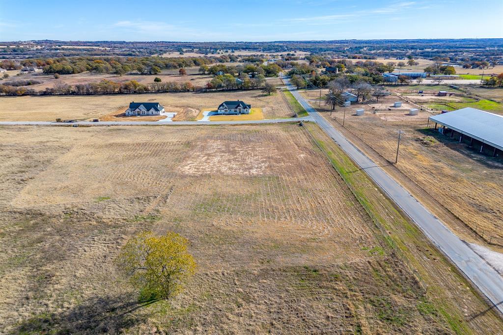 Sitting on a spacious 2 acre lot you'll enjoy peaceful country living with no HOA, no city taxes and no water bills! Located in a highly rated school district and less than an hour from Fort Worth, this home offers the best of both worlds, quiet country charm with easy access to the city. This one is move in ready and waiting for it's new owners 

Bring your own builder- or sit on it, use our builders…all options for these lots. No minimum time to have it built.