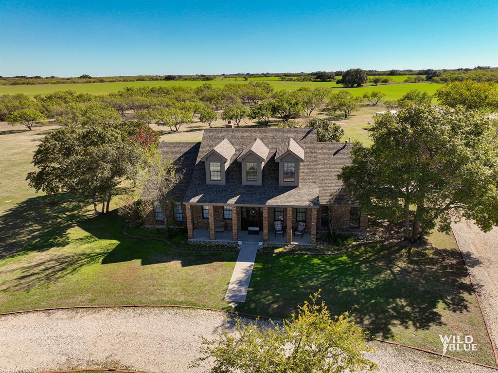 2-story brick hm blt in 1997 has all living space 1st floor (2344 sq ft) & lg game room upstairs (600 sq ft). Grand foyer, living, dining & 1 guest bedroom have 10’ ceilings. Living room has a grey stone wood-burning fireplace with wrap-around wood mantle & stone hearth. There are plenty of windows along the east wall to let in natural light & wood look ceramic tile floors for a warm and inviting feeling. Eat-in kitchen has been updated in 2017 with knotty alder cabinets & granite countertops and has slate stainless appliances including a gas range that will convey. Dining room also has ceramic tile floors & windows for natural light. Primary bedroom has vaulted 9’ ceilings & an ensuite bathroom which has a walk-in shower, dual sinks, separate walk-in closets & a garden tub. Guest bedrooms have carpet, windows for natural light & nice size closets.  Guest bath has built-in cabinets & a shower-tub combo. Laundry room has space for a freezer & extra fridge while having built-in cabinets.