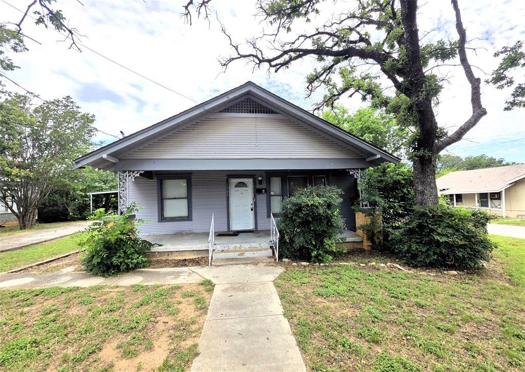 2BR 1BA home sitting on a huge corner lot with chainlink fencing.   Detached carport with a large storage building. Large bedrooms, utility room, and wood flooring throughout and some old style charm. Massive living room with faux fireplace.