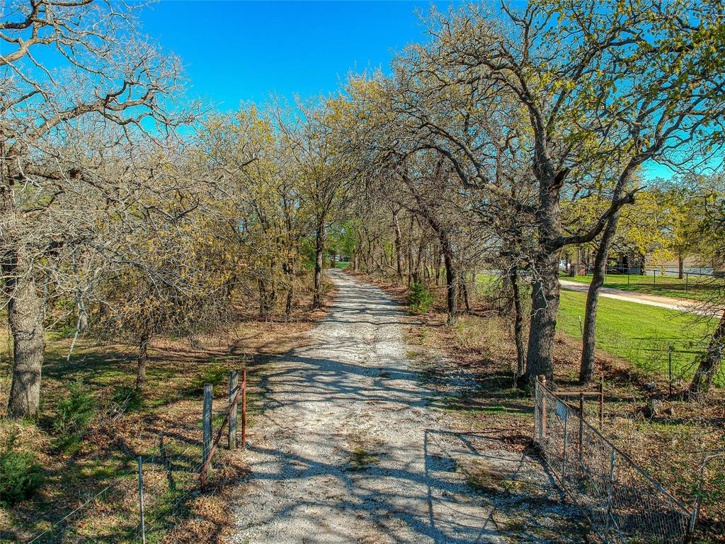 This is lot 1 of 3 available for sale ranging from 10-16 acres in Alvord, Texas. Lot 2 is MLS #20414381 and Lot 3 is MLS #20414390. Embrace the beauty of nature with dense areas adorned by mature trees and sprawling grazing pastures. Property meets requirements for agriculture exemption. Electricity is readily available on this 10 acre property, ensuring modern comfort in a serene setting. The property features a 21 x 25 storage shed paired with a convenient carport, adding both functionality and storage space. Create your dream lifestyle surrounded by nature's beauty, while maintaining easy access to city amenities and urban opportunities. This rural gem is nestled just 15 minutes from Decatur and a mere 50-minute commute to Fort Worth.