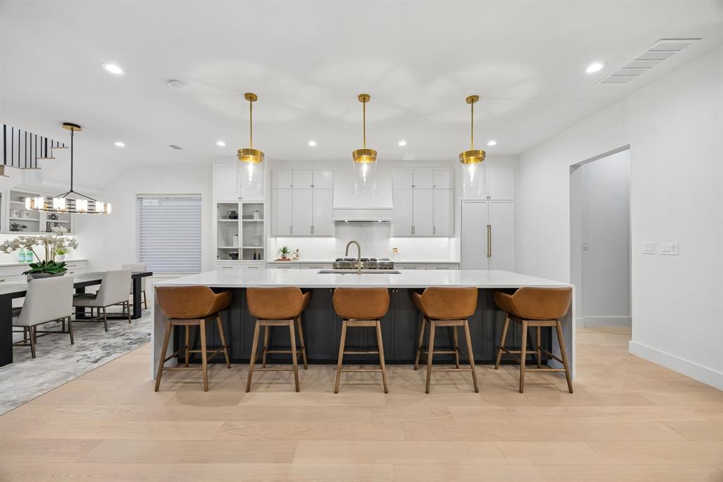 Nestled in the Little Preston Hollow neighborhood close to ESD and other top private schools, this contemporary masterpiece offers an unbeatable location and exceptional high-end finishes. Spanning over 5,600 square feet, this thoughtfully designed home exudes modern elegance and sophistication. Wide plank flooring, custom tile selections, stunning lighting and soaring vaulted ceilings enhance its luxurious appeal. Picturesque windows bring the natural light into the downstairs living areas. The gourmet kitchen features a commercial-grade gas range, built-in refrigerator, large island with waterfall edge, wet bar and a walk-in pantry with quartz countertops. Also located on the first floor is the primary suite, a tranquil private retreat with a spa like bathroom and custom closet with an additional washer and dryer hookup. Four guest bedrooms upstairs, with one serving as an optional second floor primary suite, all have generous walk-in closets. More entertaining space upstairs includes a second floor living room and a third-floor game room, wet bar and bonus room that could function as a sixth bedroom if desired. An elevator-ready layout ensures long-term convenience. Seamless indoor-outdoor living with meticulously landscaped grounds provides the perfect setting for relaxation or hosting guests. Moments from top schools, fine dining, and premier shopping, this home redefines modern luxury living.