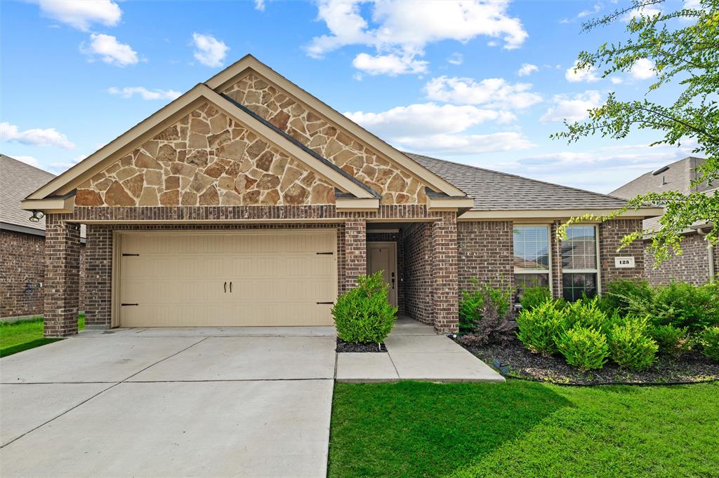Bright, inviting, and thoughtfully designed, this beautifully maintained home in the heart of Waxahachie offers the perfect blend of comfort and style. The open-concept layout features spacious living and dining areas filled with natural light, durable wood-look flooring, and a crisp modern color palette throughout. The kitchen shines with granite countertops, stainless steel appliances, abundant cabinetry, and an oversized island perfect for gathering. The private primary suite offers a relaxing retreat with dual sinks, a large walk-in shower, and generous space to unwind. Outside, enjoy a covered back patio and fenced backyard ideal for entertaining, pets, or peaceful evenings at home. Nestled in a welcoming neighborhood with charming curb appeal and convenient access to schools, shopping, and dining, this home combines easy living with timeless character.