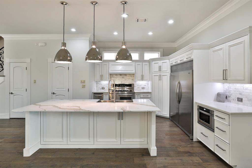 **Seller willing to contribute either $5,000 toward buyer's closing costs or potential rate buy-down with acceptable terms.** Nestled in Fort Worth’s coveted 76107 zip code, this beautifully updated home blends sophistication, comfort, and convenience just minutes from River Crest Country Club and north of Camp Bowie Boulevard. Built in 2007, the thoughtfully designed floorplan features a welcoming living room with gas log fireplace, built-ins, and sliding doors opening to one of the several private courtyards for seamless indoor-outdoor living. The expansive kitchen is ideal for entertaining with a massive island, quartz countertops, gas range, and built-in refrigerator. The first-floor primary suite offers a serene retreat with courtyard access and a luxurious marble bath featuring a jetted soaking tub, separate shower, dual vanities, and custom closet with direct access to the main floor laundry room. Upstairs includes two ensuite bedrooms both with walk-in closets, a secondary living area, and additional laundry room with an additional versatile closet or work space. Recent 2023 updates include main level wood flooring, fresh paint, quartz surfaces, designer lighting, all new PEX plumbing, while the oversized two-car garage features epoxy floors, custom cabinetry, and equipped with a generator hookup outlet.