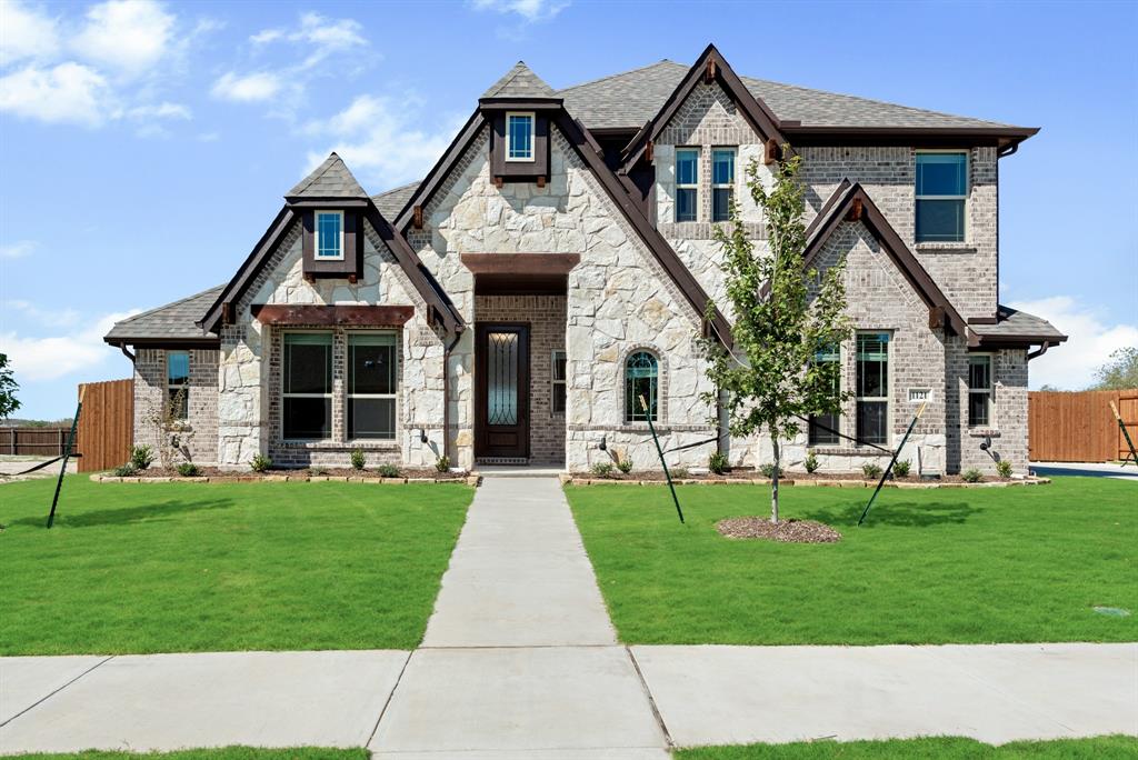 New Build, Quick Close! Bloomfield's Carolina III plan is a classic two-story that has 3 bdrms & 2 baths on the first floor and a spacious upstairs with a Game Room, Bed 4, and Bath 3. Elegant & timeless design features like an elegant rotunda foyer, archways, large windows that fill rooms with natural lighting, and an open-concept Family Room with a stone fireplace. Study & open Formal Dining off the foyer, with Hardwood floors adorning high-traffic areas. Deluxe Kitchen has all the bells & whistles: built-in SS appliances, quartz countertops, upgraded backsplash, walk-in pantry, 3 pendant lights over the island, wood vent hood, pot & pan drawers, and an adjacent Brkfst Nook for casual dining. Architectural stone & brick accented exterior, gutters, fresh landscaping, stained fencing, and a sprinkler system are included. Tons of upgrades elevate the home like an Extended Covered Patio, Blinds, and Custom 8' Front Door! Call Bloomfield at Wind Ridge to find out more!