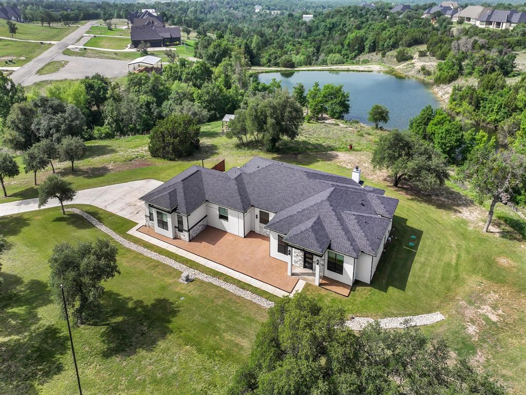 VA Assumable!  
This home offers open concept living with expansive spaces and stunning waterfront views, enhanced by large windows and abundant natural light.   Kitchen showcases a  Frigidaire appliance package that includes an 8 burner gas stovetop, double ovens along with a separate drink fridge.  Large covered and open patios provide exceptional space for entertaining and outdoor living. Wood burning and electric fireplaces add warmth and versatility. 
-3 Car garage
-Prewired for whole house generator
-White oak hardwoods throughout
-Upgraded countertops
-Includes two tv's, Samsung 75inch picture frame tv in living area and 75 inch tv on back porch, refrigerator, and flag pole