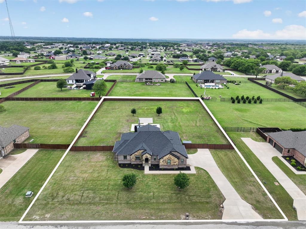 *3.5% VA ASSUMABLE LOAN* A private 1-acre retreat with a resort-style pool and brand new extended patio, this custom single-story delivers the space, upgrades, and outdoor living buyers are searching for. This stunning single-story custom home offers 2,328 square feet of well-designed living space on a full 1-acre lot in the quiet Country Hill Estates community. The backyard is built for enjoyment, featuring a play pool installed in October 2022 with a 6-foot depth, sun deck, PebbleTec finish, LED lighting, autopilot system, and cartridge filter. A covered patio added in 2024 with a remote-controlled fan, cedar fencing, and a drainage system with French drains and gutters complete the space, with plenty of room to add a workshop or sport court. Inside, the open-concept ranch-style layout offers 3 bedrooms and 2 baths with a split-bedroom design for added privacy. The spacious living area centers around a whitewashed fireplace inspired by Lueder stone and flows into the kitchen with custom cabinetry, granite countertops, double ovens, gas cooktop, built-in microwave, and a large island, along with a quartz infinity island for added style and function. A versatile flex space works perfectly as a theater room, game room, or guest bedroom. The oversized primary suite features a garden tub, separate shower, dual vanities, and a walk-in closet. Additional highlights include luxury vinyl flooring, updated window treatments, ample storage, a functional laundry room, side-entry garage, updated HVAC, electric water heater, serviced septic system, and a propane tank that has only been filled once. Located in a peaceful setting, this property offers space, comfort, and exceptional outdoor living just outside the city.