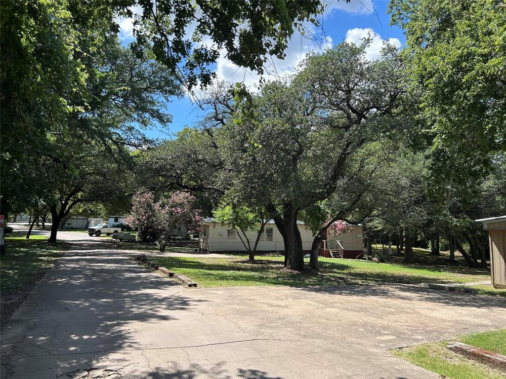 This 2.98 acre tract of land currently has 10 manufactured homes and  2 camper lots.  The manufactured homes have open title and will be converted to real property at the time of closing.  Seller is in the ongoing process of refurbishing the homes.  6 have been refurbished  and 1 is in the process.  
Proposed rents for manufactured homes are expected to be $1000 to $1250 per month and camper lots at $450 per month.  Water and household trash pick up are included in monthly rent.  The property contains two water wells.
Property is being sold AS IS WHERE IS, WITHOUT ANY WARRANTY, INCLUDING FIT FOR A PARTICULAR PURPOSE WARRANTY.

Please contact Listing Agent for any additional information.