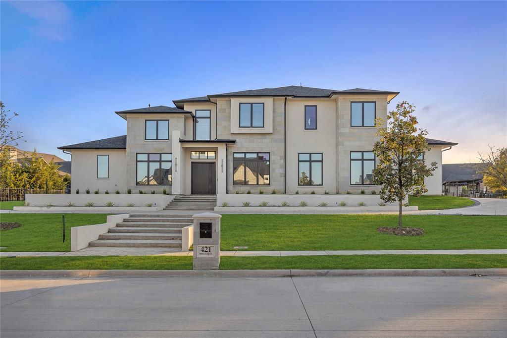Nestled in the coveted Ridge Lakes of Heath, this custom-built by USA Smart Homes residence combines timeless craftsmanship with modern luxury. Spanning over 5,100 square feet, every detail of this architectural gem exudes sophistication, comfort, and innovation.
Elegant interiors showcase four spacious bedrooms, four and a half bathrooms, and two versatile living areas for entertaining or relaxation. A private office and a media room with state-of-the-art surround sound complete the home’s sophisticated layout.

Smart home technology seamlessly controls lighting, audio, climate, pool settings and security. While the chef’s kitchen, with commercial-grade appliances and an oversized island, offers a perfect space for gatherings.

Indoor-outdoor living flows effortlessly to a resort-style backyard featuring a pool, spa, waterfall, and outdoor kitchen. Combining luxury, innovation, and serenity, this Ridge Lakes residence defines modern living.
