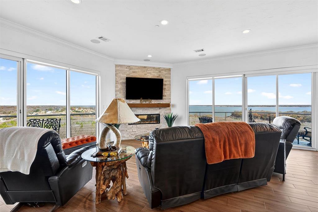 Experience premium lakefront living in this stunning 5th-floor condo in Diamond Pointe tower. North facing, the unit offers unobstructed, panoramic lake views from the private patios—two with direct vistas of the sparkling water.
Diamond Pointe sets the standard for luxury and security at Lake Texoma, boasting an unrivaled location and panoramic views. Residents benefit from a gated entrance and secure building access, with features like sprinklers throughout, an internal stairwell, and a striking glass-front elevator that offers sweeping vistas of the lake as you ascend or descend. The main lobby, thoughtfully designed, provides mail service and a dedicated space for package deliveries, ensuring convenience at every turn. Privacy and exclusivity are paramount here—there simply is no finer building in the area that combines such discretion with its outstanding setting.
Step outside to enjoy a spacious balcony, perfect for morning coffee or evening gatherings with breathtaking lake views. 
Inside, the open concept layout seamlessly combines the kitchen, dining, and living areas, highlighted by an electric fireplace and captivating lake scenery. The unit features two spacious bedrooms and an office with a desk and Murphy bed, perfect for extra guests. The primary suite boasts an en-suite bath with a walk-in shower, walk-in tub, double vanities, and two generous walk-in closets. The secondary bedroom also enjoys a walk-in closet.
Enjoy low-maintenance living with exclusive amenities, including a two-car garage in the main building, a large secured storage room on the ground floor, and two reservable guest rooms for visitors. Boating enthusiasts will appreciate the private dock slip with convenient tram access.
Ideal as a full-time residence or a luxurious lake getaway, this community welcomes both year-round and secondary owners. Embrace the best of Lake Texoma living.