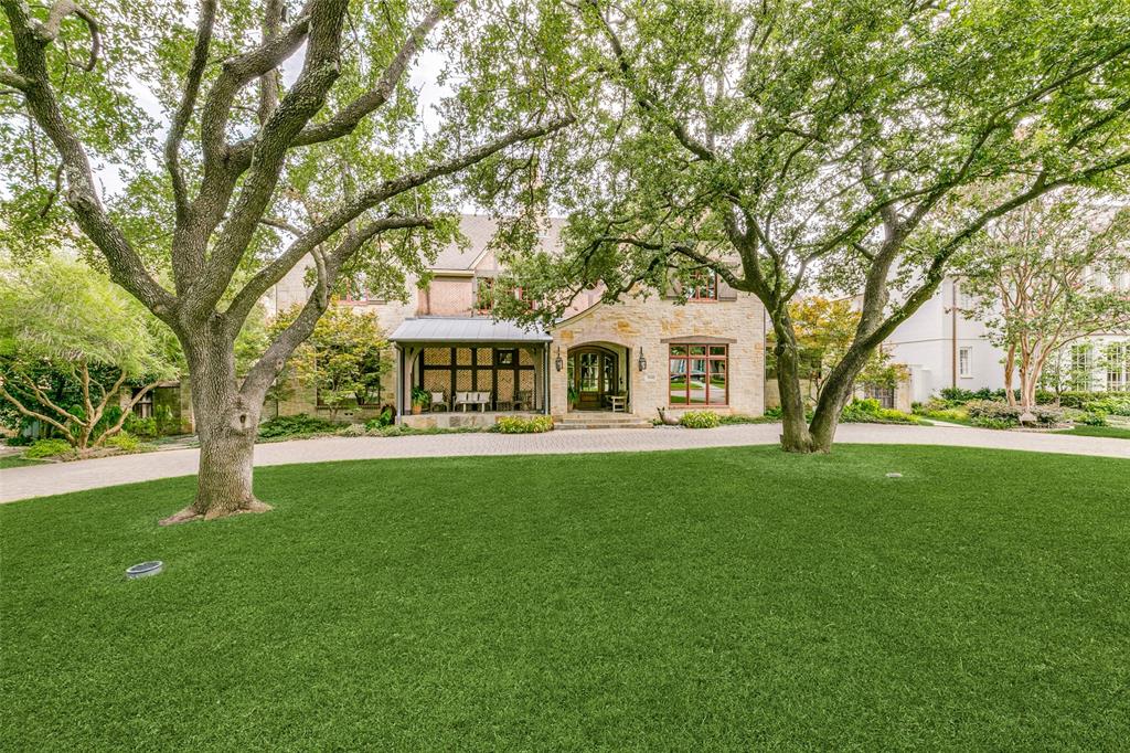 PRICED TO SELL!  Nestled in the Fairway of University Park, this timeless custom 2013 Tudor offers a relaxed yet elegant aesthetic on a prime oversized 100' x 150' heavily treed lot.  This inviting open floor plan offers a sophisticated freshly painted interior bathed in natural light throughout.  Highly sought after FIRST FLOOR PRIMARY SUITE with dual vanities and his-her walk-in closets. Soaring 14' beamed ceilings in Great Room, a striking floor to ceiling herringbone fireplace, a wall of large scale windows and rare 7 in wide plank reclaimed pine floors set the stage for this gracious home.  Two spacious dining rooms adjoin the gourmet kitchen with a premium Thermador appliance package.  The Second floor includes 4 Bedrooms, one of which could easily serve as play room, and a generous climate controlled storage room.  A masterfully designed outdoor living area includes a grilling station, outdoor fireplace and ample gathering space overlooking a lush landscaped backyard.