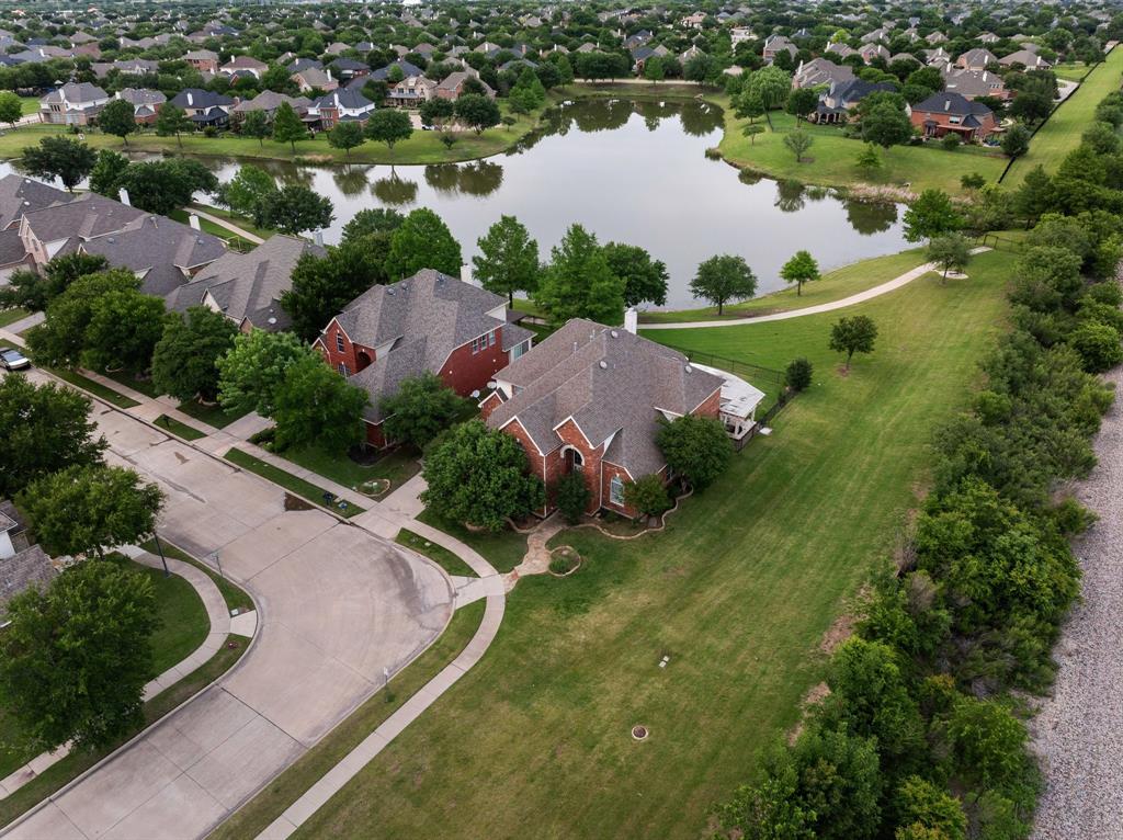 Now offering $10,000 in seller concessions! Amazing waterfront home in the exclusive gated community of Heritage Lakes. This unique property is one of the few with direct access to the community's scenic trails. Located adjacent to a beautifully maintained green space, courtesy of the HOA, offering the perfect spot for outdoor recreational sports. Heritage Lakes offers resort-style amenities including a lazy river, a newly updated indoor gym and studio, as well as a 9-hole par-3 golf course, and catch and release fishing. With all this just 7 minutes from The Star and close to North Texas' top destinations—The Shops at Legacy, Stonebriar Mall, Grandscape, PGA Frisco, and the upcoming Universal Studios water park. Home is also conveniently located 25 minutes from DFW airport. Schedule your private tour today and discover the unmatched charm of waterfront living in Heritage Lakes