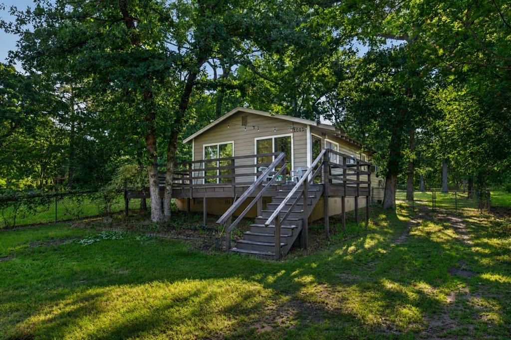 Charming home on three lots in the desirable Cedarcrest Shores community at Cedar Creek Lake! Nestled on approximately .34 acres, this property offers a rare combination of space, privacy, and lake lifestyle living.

Inside, you’ll find an inviting open-concept living area with original hardwood floors and a functional kitchen layout that flows easily for everyday living or weekend getaways. The spacious primary bedroom features direct access to the backyard, creating a seamless indoor-outdoor feel.

Step outside to enjoy the large front deck—perfect for morning coffee or relaxing evenings—along with a fenced backyard, mature trees, and a storage shed for added convenience. With access from two streets, the property offers flexibility and ease of use.

Located just minutes from the community’s private boat ramp and dock, you’ll have quick access to Cedar Creek Lake for fishing, boating, and enjoying the outdoors. Positioned on the west side of the lake, this home also provides an easy commute to Corsicana, Kaufman, and Dallas.

Whether you're looking for a full-time residence, weekend retreat, or investment opportunity, this property offers incredible potential in a lake community setting.