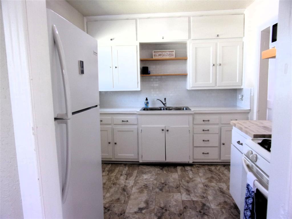 This cute little 3 bedroom 1 bath is a perfect starter home or a great investment opportunity. It has been recently updated with new light fixtures, hardware, flooring, paint, new bathroom cabinet and new subway tile around the tub shower combo. It also has two window units and two wall heaters. You will love all the natural light this property has to offer. The hardwood floors are beautiful. Enjoy entertaining in your large sized backyard. It could have a really cute curb appeal as well by adding a few flowers and bushes. There is also a garage and this is where you find the washer and dryer hookups. Don't miss this opportunity as nice move in ready houses at this price are hard to come by here is San Saba. Call me Today and let's connect.