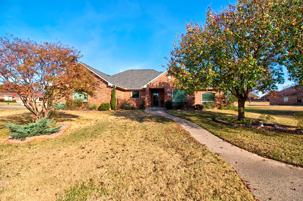 Welcome to this fabulous home on a large, corner lot. The heart of the home is an updated kitchen with oak cabinets and an island that seats four. You will enjoy cooking in the gorgeous kitchen with upgrades including granite counters, cabinetry, and gas cooktop. The large dining area will accommodate an oversized dining table and is accented with beautiful new lighting. The spacious living room has new ceiling fans, updated recessed lighting, a wood burning fireplace and a dedicated game area. All bedrooms are generously sized and the primary bedroom has a large walk-in closet with built-in storage. The family room and all bedrooms have beautiful new LVT flooring. The stunning fenced back yard has a pergola covered patio with a remote controlled sun-privacy screen. There is attractive landscaping with irrigation and a cement walkway that  leads to a side entry and secondary patio. The home features a whole house generator and oversized propane tank.  Other improvements include a 3 zone gas heating system, storm doors, an oversized garage with room for your golf cart and workshop area, as well as extra parking for all your friends and family. Additional highlights include a spacious laundry with sink, stylish fixtures throughout, and a welcoming exterior with excellent curb appeal. The Lake Kiowa community is truly amazing! It is a gated lake with 24 hour security. The lake is private to property owners and offers boating, skiing, fishing and swimming.  There are two beaches and a clubhouse with restaurant. Unlimited, free golf is available to owners with an 18 hole course as well as a 9 hole par three course.  Many clubs and organizations at offer fun and entertaining activities for all members of the family!