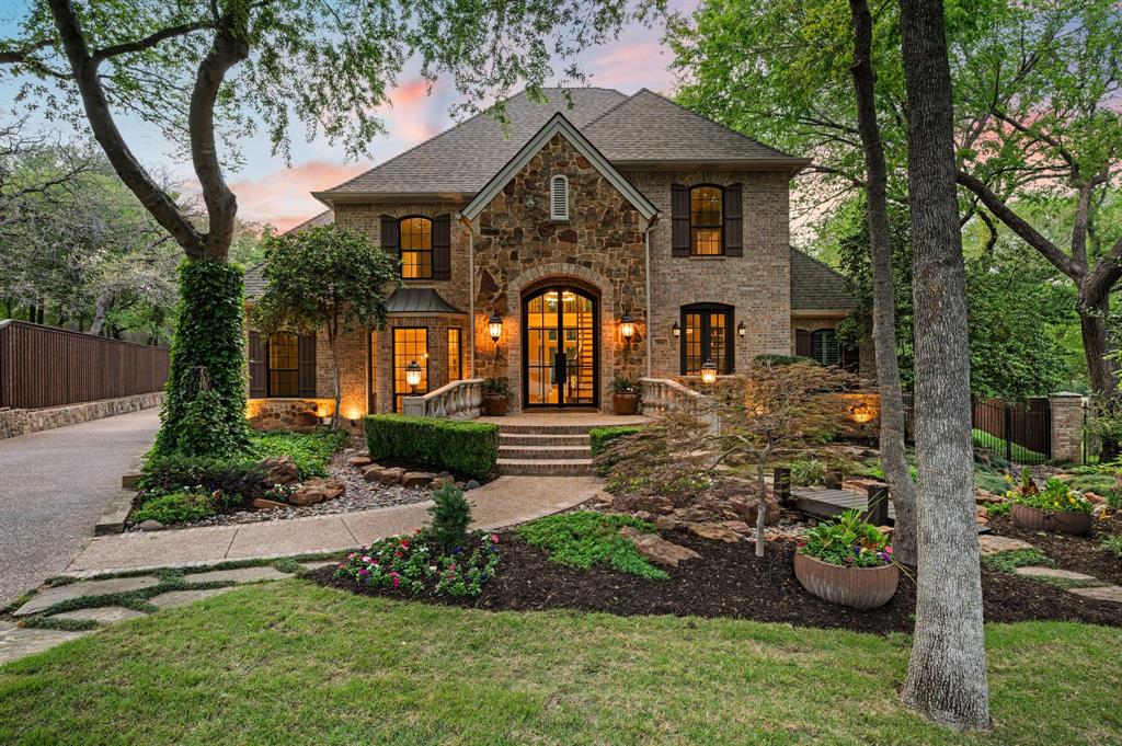 Upon entering the prestigious, guard-gated community of Monticello Estates in the heart of Southlake, tree-lined streets lead you to the end of a quiet cul-de-sac, where the neighborhood’s premier oversized-lot awaits. Curb appeal wows with newly installed Traditions Windows, serene landscaping, and brand-new steel and glass double front doors which create a stunning first impression, beautifully blurring the line between indoors and out. Inside, the dramatic staircase is crowned by a striking new chandelier, while updated visual comfort lighting enhances the home with warmth and sophistication at every turn. Flanking the foyer, a richly color-drenched executive office and a designer-wallpapered dining room create elegant spaces for both work and entertaining. The residence offers five generously sized bedrooms, including two on the main level and three upstairs, all fully updated including quartz countertops, new lighting and tile.  In addition, the home features an expansive game room with wet bar, a fully equipped fitness studio, and a spacious laundry suite with room for oversized appliances. At the heart of the home, the chef’s kitchen is a true showpiece. New stunning Taj Mahal quartzite island anchors the space, complemented by soft cream cabinetry, an oversized double Wolf Range with six burners and an expansive griddle, a panel-ready Sub-Zero refrigerator, Wolf microwave, and double Blanco sinks. New dramatic two-story, double-paned windows frame sweeping views of the nearly three-quarter-acre grounds, showcasing a private, tree-filled and park like backyard oasis complete with a pool, spa, and expansive outdoor living space including new AOG grill, fully equipped kitchen, living and dining spaces. Other upgrades include mosquito mister system, Zosia sod, all new plumbing throughout home, a massive 4-car garage, extended driveway, and extra-high board on board fencing that provide added privacy and functionality. All this in the award-winning Carroll ISD!