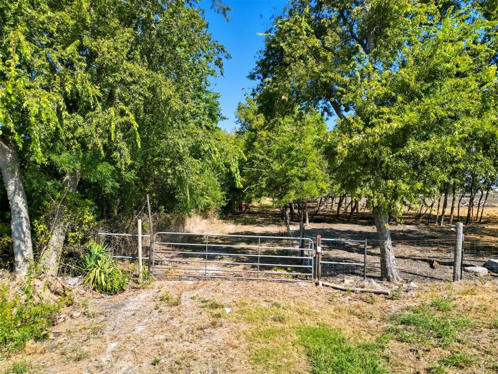 Hunter’s paradise just 7 miles north of Greenville off Highway 34! This 13.564-acre tract is mostly heavily wooded, offering abundant wildlife, natural privacy, and a peaceful rural setting. A seasonal creek runs through the property, adding natural character and attracting wildlife. There is a clearing near the front that the seller indicates could be suitable for a future homesite outside the floodplain. Property has direct frontage on FM 3427, with access through a gated entry — the gate is the only visible frontage from the road. Approx. 30–40% of the land lies in FEMA Zone A floodplain — buyer to verify. No HOA, no MUD, and no known restrictions.

The seller is also leaving a travel trailer on-site, located in the cleared area — a great option for weekend stays or staging during future development. Perfect for hunting, weekend getaways, or creating a quiet, secluded place to call home.

All information deemed reliable but not guaranteed. Buyer and buyer’s agent to perform their own due diligence regarding floodplain, utilities, easements, and all property details.
Note: Seller currently allows a neighbor to graze cattle on the property by permission only. Livestock will not be included in the sale, and no formal lease will convey.