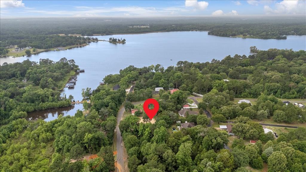 Build your dream near Lake Holbrook on this cleared and ready-to-build .24-acre lot just a short distance from the lake. Dirt work has already been completed, giving you a head start on creating your ideal getaway, full-time residence, or weekend retreat. Slightly elevated above the road, the property offers a stately feel and added character, creating the perfect setting for a future home surrounded by the peaceful beauty of East Texas. Tucked away with no direct neighbors nearby, you’ll enjoy privacy and a quiet atmosphere while still being conveniently located near shopping, restaurants, and everyday necessities. Spend your days fishing, boating, at the community beach or park, or simply unwinding near the water while embracing the relaxed lifestyle that makes lake living so appealing. Whether you envision a cozy cabin or custom home, this property offers the perfect opportunity to create your own private escape near the lake.