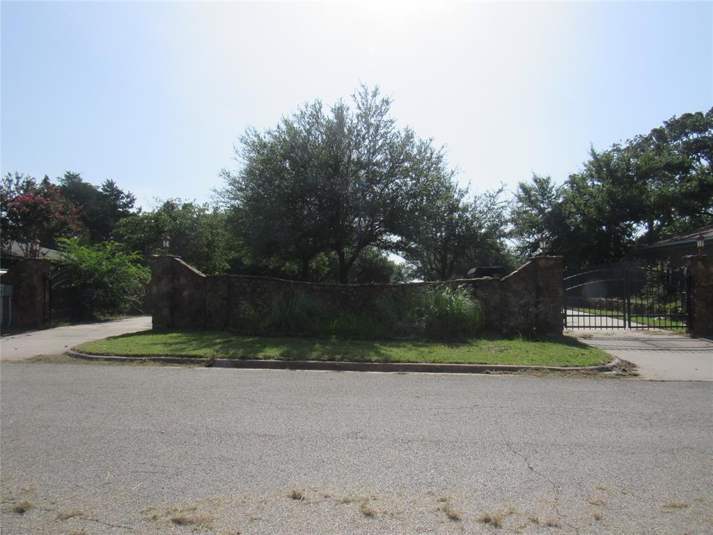 TWO CONCRETE DRIVES WITH STONE AND IRON GATES ON EACH SIDE COMPLETED AS WELL AS STONE FENCE SURROUNDING PROPERTY, BACK CONCRETE PATIO FEATURES HUGE 6 FT PLUS BBQ PIT FOR THOSE COOL FALL NIGHTS -OASIS ---- ESTIMATED $200,000 WORTH OF STONE WORK WITH WALLS, WALKWAY AND GRILL AND ESTIMATED $85,000 IN CONCRETE BETWEEN DRIVES AND SLAB ON BACK SIDE.   Close to retail, medical, dining and entertainment, 1 min from Hwy 75, If a private back yard oasis is your thing, this land is a must see! The possibilities are endless with drives, slab and stone fencing surrounding... Schedule your appointment today!  Utilities are on the property - take a drive by and look at this amazing stone fenced lot in the heart of Denison.