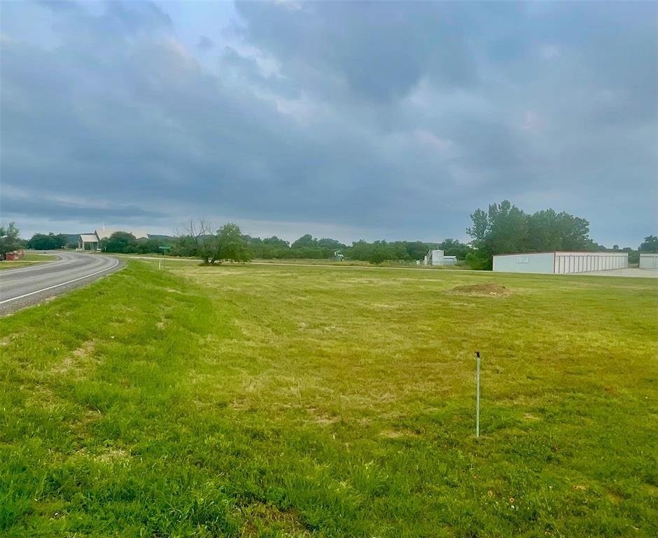 Seller says 'here's your chance'! Possum Kingdom Lake is a continually growing community ~ come grow with us!  Bring your local business dreams to life with this unique land opportunity near Possum Kingdom Lake just waiting for your improvements! Over 1.5 acres situated on a main thoroughfare, with so much potential. This is an unincorporated area, so the lot is un-zoned, but is situated in the business section of PK, close to RV parks, Willow Beach Marina, Community Church, storage, shopping, industrial, dining, and professional offices.  It would make an ideal business location for a coffee shop, office space, gift shop, storage facility, etc.  The only deed restrictions that the seller is aware of is it cannot be used as a real estate office location (the building next to it, now Brazos Title, was formerly a real estate company). A bid of approximately $15,000 was received in March 2025 for fill dirt and leveling. A water meter is believed to be reserved with PK Water Supply Corporation, but not installed, so you have options for placement when building.  Come take a walk and envision your future at PK!