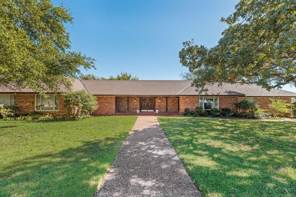 Historic luxury & endless possibilities!  When you think picturesque, small Texas town, this is the place!  This single-story ranch style masterpiece sits on a hill with majestic oaks, overlooking the highly sought after neighborhood.  Boasting almost one acre, this property offers an elegant estate featuring 4 bedrooms and 3.5 bathrooms.  Walk directly into this well maintained 1960's-time capsule, greeted by the formal dining and living room that flow seamlessly together displaying floor to ceiling picture windows while showcasing the back patio area.  A gourmet kitchen includes island, double oven and three large pantries for plenty of storage. Entertaining will be a breeze in the grand room with the custom-built, oversized buffet perfect for an extended serving line while enjoying the vaulted ceilings and additional space for guest seating.  On the opposite side of the home, the primary bedroom exhibits floor to ceiling windows for easy access to the back patio for morning coffee.  Down the majestic hallway, the laundry area sits across from a custom cedar closet and hallway also includes several storage areas.  Around the corner, there are three additional bedrooms all having ample closet space and two full baths.
Unbelievable attic space would make an ideal media or game room, the possibilities are endless, bring your wildest ideas to life! Additional features of the home include custom built pier and beam foundation with 3' crawl space, grass-cloth wallpaper and an expansive backyard with privacy fence. 
Perfect for investors or renovating enthusiasts!!!