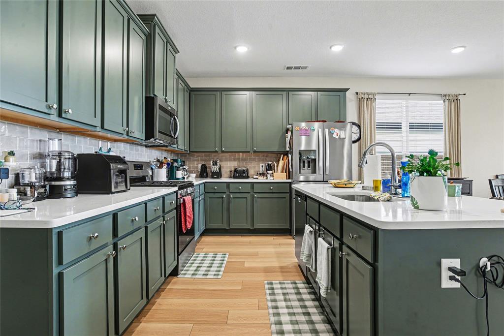 Welcome to 8134 Grotto Drive in the highly sought-after Waterscape community of Royse City, where modern design and everyday comfort come together beautifully. At the heart of this stunning home is the show-stopping chef’s kitchen—thoughtfully designed with elegant quartz countertops, oversized island seating, sleek 42-inch cabinetry, gas cooktop, and abundant prep and storage space perfect for entertaining or gathering with family and friends. The open-concept layout allows the kitchen to seamlessly flow into the spacious living and dining areas, creating a warm and inviting atmosphere filled with natural light.

This beautifully crafted home also features spacious bedrooms, stylish finishes, luxury vinyl plank flooring, and a private owner’s retreat with a spa-inspired bath and oversized walk-in closet. Step outside to enjoy the covered patio and low-maintenance backyard, ideal for relaxing evenings or weekend get-togethers. Located in the resort-style Waterscape community with pools, trails, ponds, and parks, this home offers the perfect blend of comfort, style, and convenience.