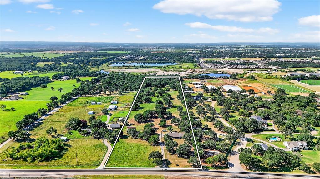 Positioned in the heart of one of North Texas’ fastest-growing corridors, this exceptional 14-acre tract presents a rare opportunity for investors, developers, entrepreneurs, and landowners seeking flexibility, visibility, and long-term upside. Located within the Aubrey ETJ and situated along a major high-traffic thoroughfare, the property offers outstanding accessibility and exposure in an area experiencing explosive residential and commercial growth. With no known restrictions and no city zoning oversight, this property provides the freedom to bring virtually any vision to life. Whether you are planning a commercial development, business headquarters, RV park, contractor yard, event venue, private estate, equestrian facility, agricultural operation, or long-term investment hold, the possibilities are truly limitless. The property features a well-maintained brick home already in place, offering immediate functionality as a residence, office space, rental property, or operational headquarters while future plans are developed. Existing improvements combined with nearby water and electric availability create a strong foundation for future development and investment. Strategically located in the rapidly expanding North Texas growth path, this tract benefits from increasing traffic counts, nearby residential expansion, and continued demand for commercial and mixed-use opportunities. Large unrestricted tracts with prime roadway frontage are becoming increasingly difficult to find, making this an exceptional opportunity to secure acreage in a highly sought-after location before values continue to rise.