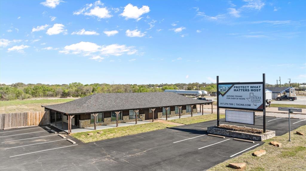 Presenting a unique opportunity at 4400 E US Highway 377, this property features a beautifully
updated 1,471 sq. ft. office building situated on 1.76 acres of commercially zoned land. With
exceptional visibility and direct frontage on Granbury's main commercial corridor, this location
is perfect for any business seeking a turn-key space with incredible room to grow. Property
allows for two entrances, one on US Hwy 377 and the other on Shannon’s Run.
The office interior has been tastefully modernized, featuring a welcoming reception area,
private offices, and a stylish, functional layout ready for immediate occupancy. Outside, the
building boasts an attractive stone and wood exterior, complemented by a newly paved and

striped parking lot that provides ample space for clients and staff.

The rear of the property includes a large, cleared, and level lot, offering a rare opportunity for
future expansion. Whether you envision constructing a second building, creating a spacious
laydown yard, or simply securing room for future growth, the potential is limitless.
Property Highlights:
Turn-Key Office: 1,471 sq. ft. of modern, move-in-ready office space.
Large Lot: Situated on approximately 1 acre.
Expansion Ready: Significant vacant land at the rear for future development.
Prime Location: High-visibility frontage on E US Highway 377.
Ample Parking: Newly paved and striped on-site parking lot.
Versatile Use: Ideal for professional services, medical, retail, or as a corporate headquarters. Includes the lot behind the building as well!
Don't miss this chance to establish your business in a prime Granbury location with abundant
space and future potential.