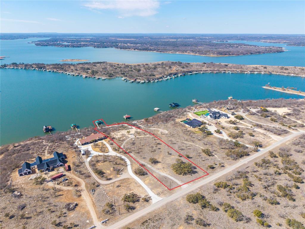 Lakefront Luxury Awaits at Deepwater Estates.
Experience the best of lakefront living on this premier 3+ acre waterfront lot, situated on the deepest water of Lake Brownwood. Nestled within the highly desirable Deepwater Estates—the area’s most prestigious gated luxury subdivision—this expansive property offers the perfect canvas to build your custom dream home.
This property features a large boat dock equipped with a hydro-lift boat slip, two jet ski slips, and an 18-foot water depth. Whether you are hosting on the spacious covered deck or soaking up the rays on the expansive upper-level sun deck, the layout is designed for optimum enjoyment and entertaining.
A new concrete driveway was recently installed, providing easy access down to the shoreline, along with a large parking area landing. A wide concrete sidewalk leads directly to the dock walkway. 
This is a rare opportunity to secure a legacy property in a private, gated community. Come build your dream home on the lake and start enjoying all the relaxation and fun activities Lake Brownwood has to offer.
Owner may consider seller-financing.