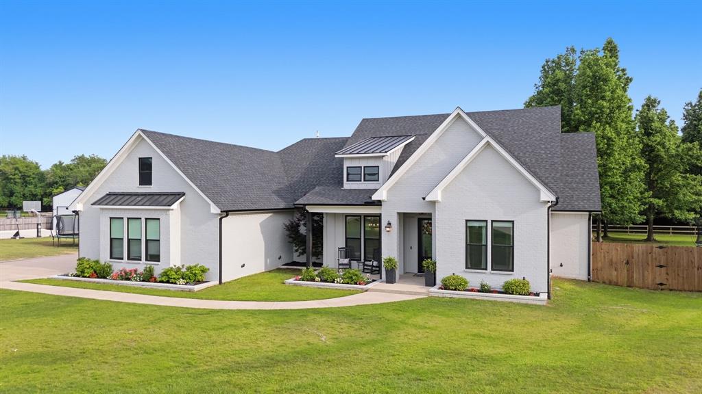Welcome to 21836 Country Meadows, an exceptional 2021-built home that perfectly blends modern design with peaceful country living. Situated on a beautifully maintained 1-acre fenced lot, this property offers both privacy and space while maintaining a warm, inviting atmosphere. From the moment you arrive, you’ll be drawn in by the home’s picture-perfect curb appeal, featuring clean architectural lines. Step inside to an immaculate interior where every detail has been thoughtfully designed. Just off the entry, the dining room makes a statement with its painted wood accent wall, creating a stylish and welcoming space for gatherings. The living room showcases stunning wood beam accents, a cozy center fireplace, and custom built-ins that add both charm and functionality. The open-concept design flows seamlessly into the kitchen, where you’ll find custom cabinetry, a gas range, and a spacious hidden walk in pantry. The primary suite is conveniently located off the kitchen along with a dedicated technology room which is ideal for a home office, workspace, or flex area. The master bedroom is a true retreat, featuring wood-accented ceilings and a sliding barn door leading into the luxurious ensuite bath, complete with a walk-in shower, standalone soaking tub, and an oversized closet with built-ins. Two generously sized bedrooms with walk in closets, share a well-appointed bathroom. A fourth bedroom includes its own ensuite bath and private exterior access, making it perfect for multigenerational living.  Step outside to enjoy covered patio which offers ample space for outdoor dining and lounging. The backyard is truly the highlight of this property, featuring a stunning pool with an attached hot tub and slide—perfect for entertaining or relaxing in your own private oasis. This home combines thoughtful design, high-end finishes, and incredible outdoor living—all in a serene country setting. Don’t miss the opportunity to make it yours.