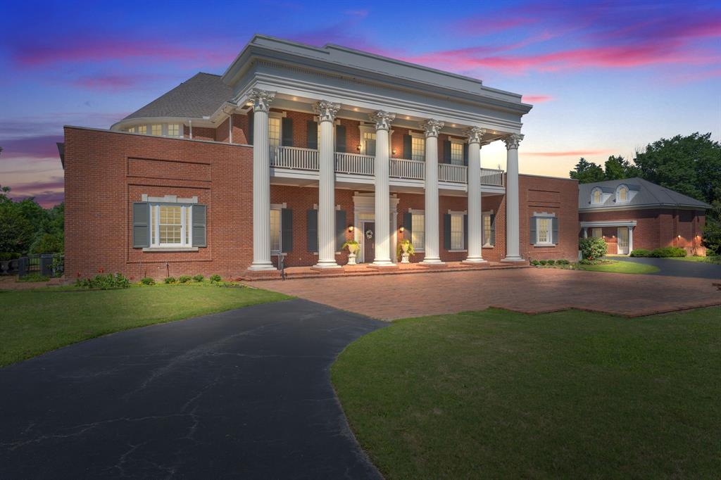 A truly extraordinary Texas estate inspired by history, scale, and legacy living.  2300 Panorama Court is a remarkable replica of The Hermitage — the iconic home of Andrew Jackson in Nashville — masterfully blending timeless Southern grandeur with the privacy and luxury today’s elite buyers demand. Situated on just under 7 acres, and boasting of 8,800 SF property offers unmatched privacy, scale, and versatility in the heart of DFW. The stately main residence features expansive living areas, abundant natural light, and timeless architectural details, ideal for both everyday living and large-scale entertaining. Generous bedrooms, multiple living spaces, and refined finishes throughout create a seamless blend of historic charm and modern comfort. The grounds function as a private compound with multiple structures, including a guest house, greenhouse, and a separate music hall or bonus house—perfect for a studio, office, gym, or additional living quarters. A private lake anchors the property, offering serene views and a rare resort-style setting in Arlington. Mature trees, open green space, and gated privacy provide a secluded retreat just minutes from major highways, dining, and entertainment in the Dallas-Fort Worth metroplex. A rare opportunity to own a landmark estate with acreage, water features, and multiple residences in one of Arlington’s most desirable gated communities.