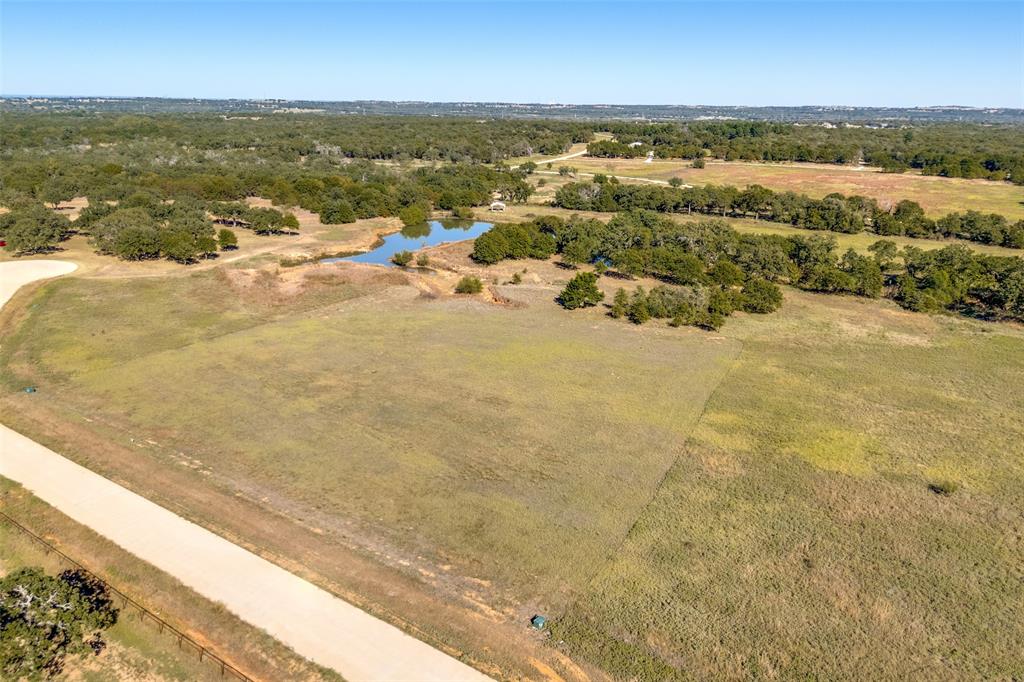 Welcome to The Reserve at Shadle—a modern, gated acreage community in beautiful Poolville, Texas, where open skies meet refined country living. Each homesite starts at 2+ acres, offering the perfect blend of tranquility, space, and upscale rural charm.

This 2.34-acre homesite offers stunning views, mature trees, and the flexibility to build the lifestyle you’ve always imagined. Bring your own builder and design a custom home, modern farmhouse, barndominium, or shop—with a minimum build requirement of only 1,250 sq ft. You’ll enjoy the freedom to raise animals, add a workshop, or simply embrace the peace and privacy that come with acreage living.

The Reserve at Shadle was designed for comfort and connection—with no thru-streets, the community stays peaceful for walks, biking, or horseback riding, and features picnic areas and scenic ponds to unwind and enjoy the outdoors. Utilities include electricity at the lot line, with buyer to install well, septic, and propane, allowing for a truly self-sufficient setup.

Located just 20 minutes from downtown Weatherford and 20 minutes from Springtown, you’ll have easy access to shops, dining, and schools while enjoying the slower pace and natural beauty of Poolville.

Experience the perfect balance of modern country living—where you can build freely, live privately, and still stay close to everything. Don’t miss this opportunity to own a piece of Poolville paradise in The Reserve at Shadle.