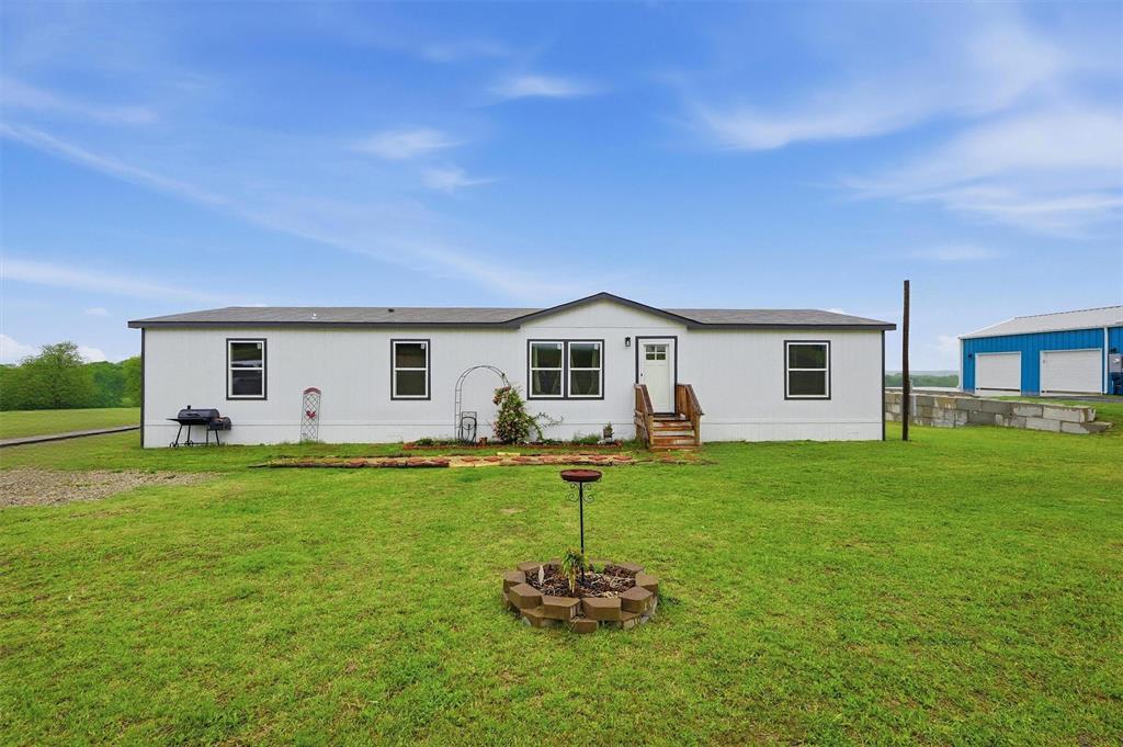 Discover the perfect blend of comfort, space, and country charm with this beautiful 4-bedroom, 2-bath manufactured home situated on a gorgeous 1-acre lot in the highly sought-after Whitewright ISD! From the moment you arrive, you’ll appreciate the peaceful setting and breathtaking backyard views that make this property truly special.

Inside, you’ll find a spacious open-concept layout designed for both everyday living and entertaining. The large living area flows seamlessly into the kitchen and dining space, creating the perfect gathering place for family and friends. The kitchen features a must-have center island with plenty of prep space, abundant cabinetry, and room for everyone to gather around.

With four generously sized bedrooms, there’s plenty of room for a growing family, guests, or even a home office setup. The private primary suite offers a relaxing retreat, while the additional bedrooms provide flexibility and comfort for everyone.

Step outside and enjoy the beauty of wide-open views and peaceful evenings in the backyard, the perfect place for kids to play, entertaining guests, or simply unwinding after a long day. This home is move-in ready and waiting for its next family. Just bring your furniture and start making memories! Properties offering this much space, scenery, and value in Whitewright ISD do not last long, this is truly a must-see!