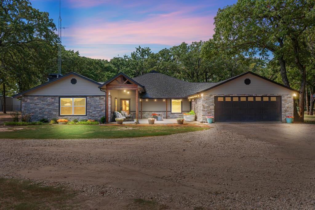 Discover a rare Texas ranch estate designed for modern living, income opportunities, and lifestyle amenities. A commercial-grade gated entrance with pipe fencing and a tree-lined driveway provides privacy and curb appeal from the moment you arrive. The acreage is primarily cleared, cross-fenced for cattle, and currently in hay production. A scenic 5± acre stocked lake with fishing pier and pavilion anchors the property, ideal for recreation, relaxation, and outdoor entertaining.
The main residence is a modern ranch-style home offering an open-concept floor plan, enhanced by fresh paint, natural light, and recently installed wood-look laminate flooring. The updated kitchen includes custom cabinetry, quartz countertops, and a large walk-in pantry. The remodeled primary suite features a walk-in shower and custom closet. Additional improvements include a patio and porch lighting, trimmed porches, and a mudroom with built-in storage. A 60’ Wi-Fi tower supplies internet and TV service to the main home.
Improvements extend outdoors with the addition of a 2 car garage,  two approximately 3,600-sqft shops equipped with electricity and concrete floors, an additional powered shed, and a storage container. The property also includes two additional residences: a 2016 manufactured home with 3 bedrooms and 2 bathrooms (approximately 1,392 sqft), and a 2-bedroom, 1-bath guest home (approximately 1,077 sqft) featuring a garage, shed, covered porch, turfed backyard, granite countertops, and open-concept design. 
Also included, a basketball court, playground, outdoor pavilion, and a chapel. This versatile estate supports ranch operations, multi-generational living, recreation, and potential rental income. Ideal for buyers seeking a working ranch, private family compound, or acreage property with multiple homes, this offering delivers flexibility, space, and long-term value in one setting.